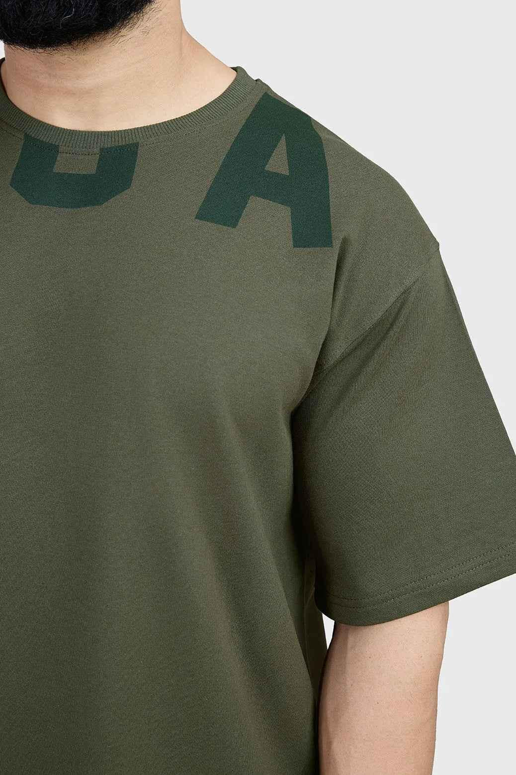 Olive green oversized T-shirt by Fuaark Nz with a relaxed fit, made from soft fabric, perfect for casual and effortless style.