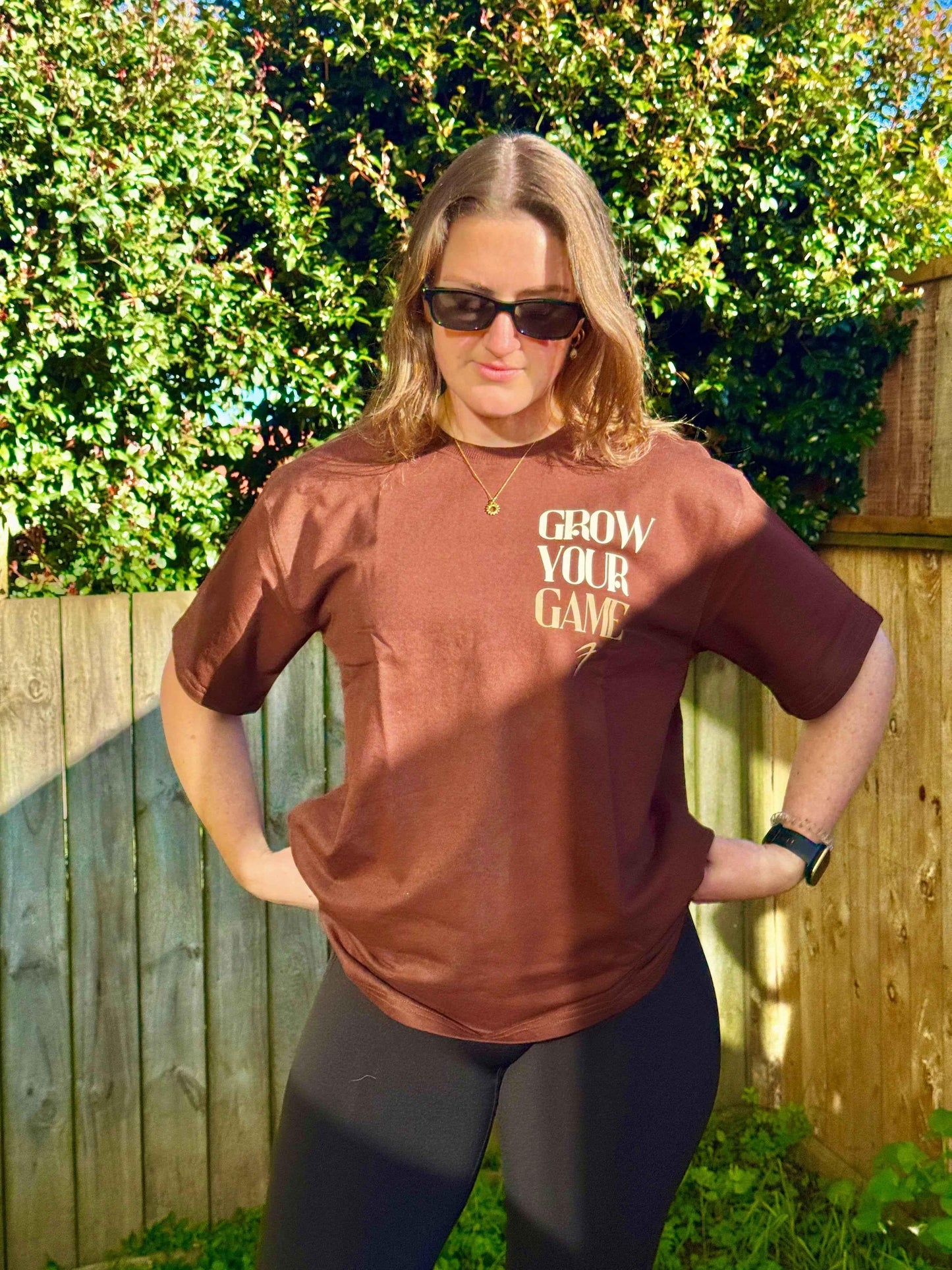 Unisex oversized coffee-colored T-shirt by Fuaark Nz, made for ultimate comfort, shown on a model with casual styling.
