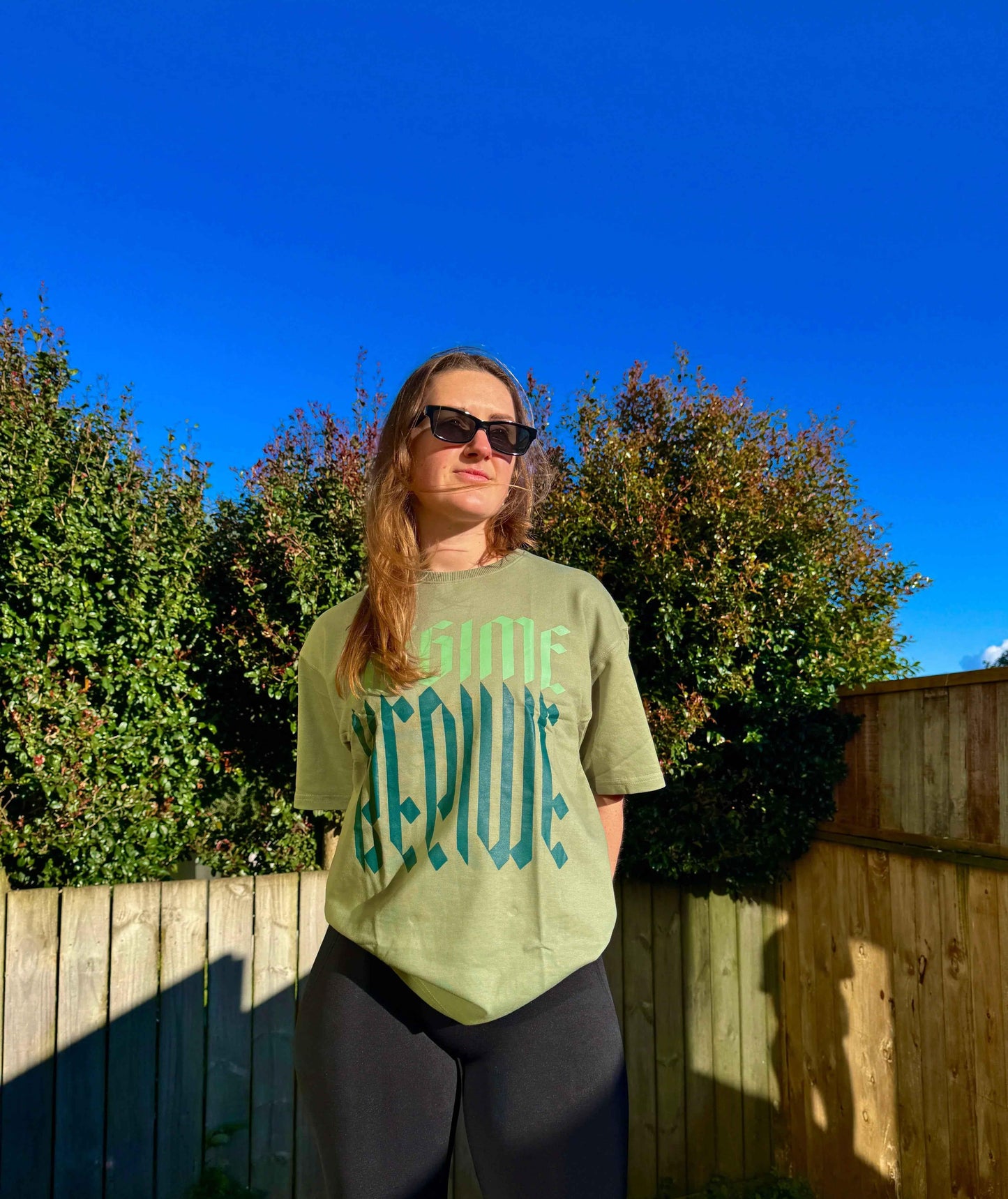 Unisex oversized Sage Green T-shirt by Fuaark Nz featuring a relaxed fit and casual style.