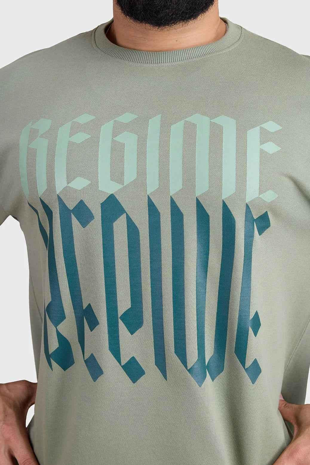 Unisex oversized sage green T-shirt by Fuaark Nz with relaxed fit and casual style, front view.