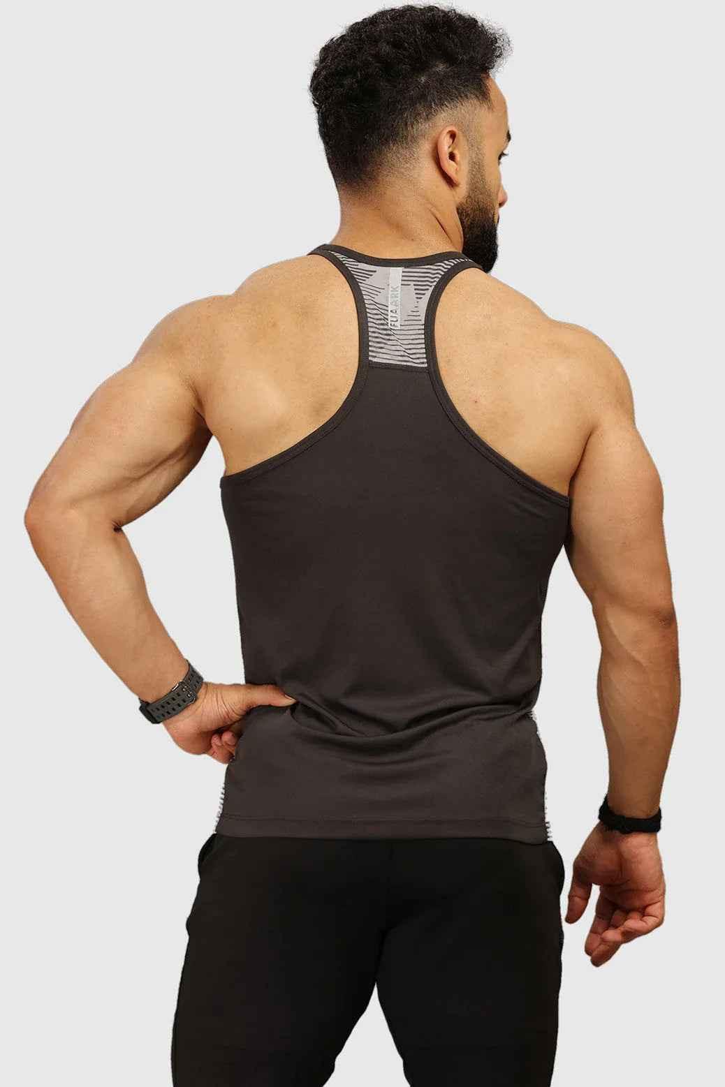 Light grey Amplify Stringer tank top by Fuaark Nz, showing close-up of sleeveless, fitted athletic design with soft fabric.