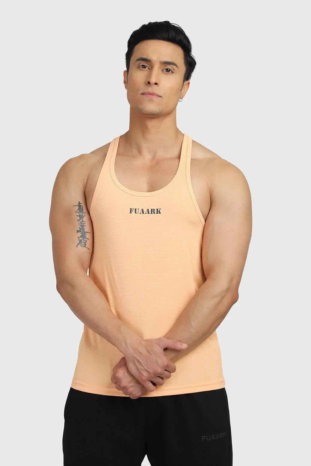 Peach Checks Stringer tank top by Fuaark Nz, featuring a sleeveless design with checkered pattern and fitted style.