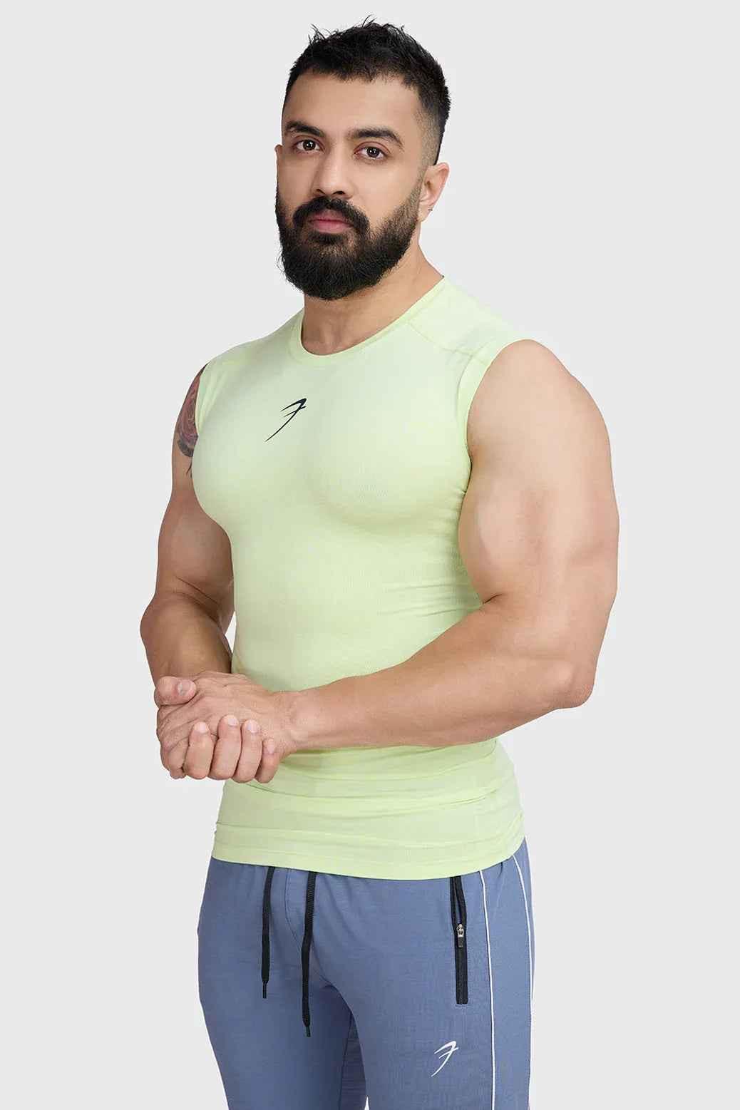 Lime green Fuaark NZ compression sleeveless tank top for athletic training and workout sessions.