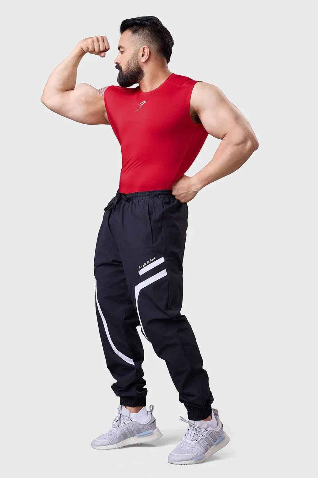 Red compression sleeveless tank top by Fuaark NZ, designed for performance and athletic wear, shown on a model.