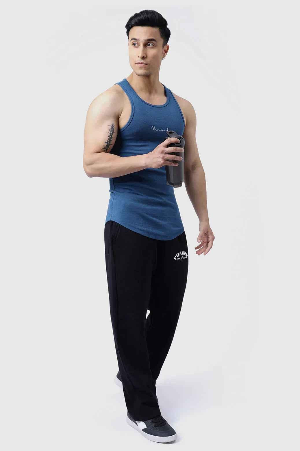 Teal ribbed tank top for men by Fuaark Nz, close-up of fabric texture and fit on a model, casual style for warm weather.