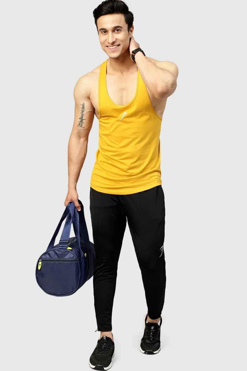 Mustard Fuaark Nz Legacy Stringer tank top hanging on a display mannequin.