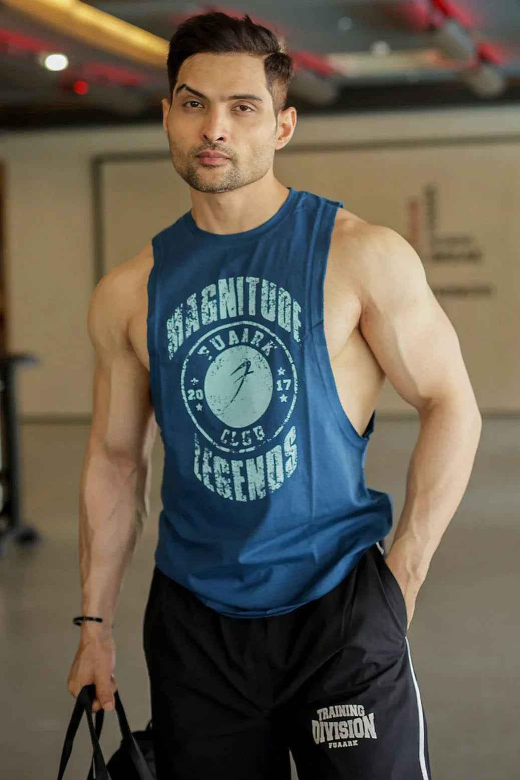 Fuaark Nz Magnitude Deep Arm Tank in teal, sleeveless tank top with a relaxed fit and deep armholes for casual wear.