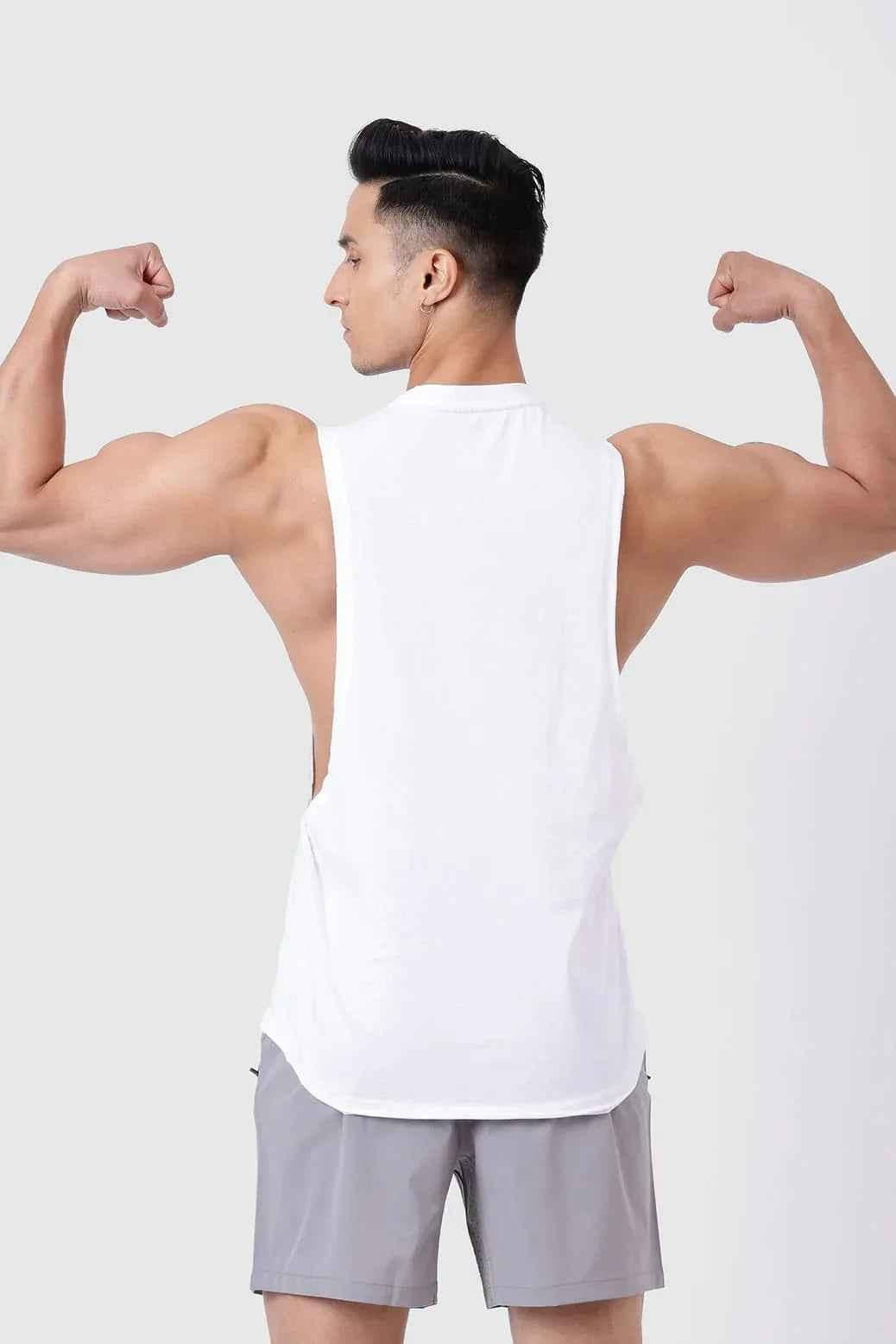 White Fuaark NZ Magnitude Deep Arm Tank Top displayed on a hanger, showcasing its sleeveless design and casual fit.