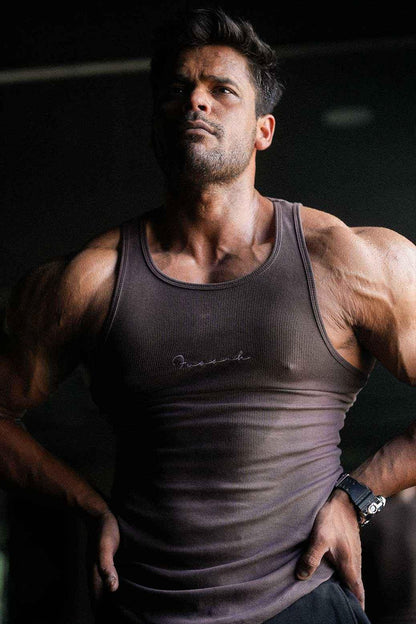 Brown ribbed tank top from Fuaark Nz, close-up of fitted sleeveless shirt with ribbed texture and scoop neckline.