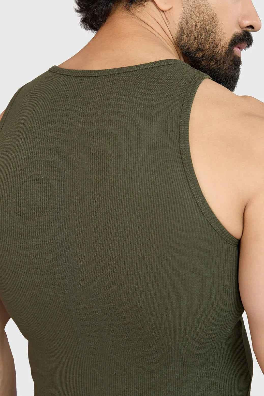 Olive green ribbed tank top by Fuaark Nz, showcasing a fitted sleeveless design with ribbed texture for a casual look.