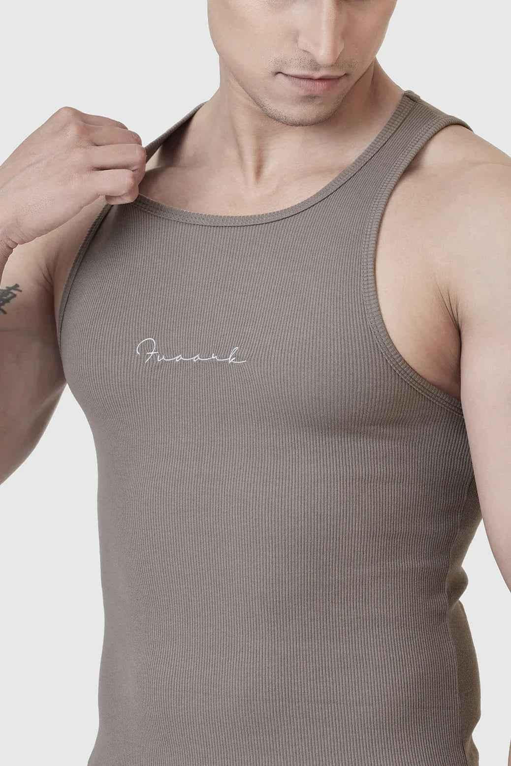 Warm beige ribbed tank top from Fuaark Nz, showcasing a fitted sleeveless design with textured ribbed fabric.
