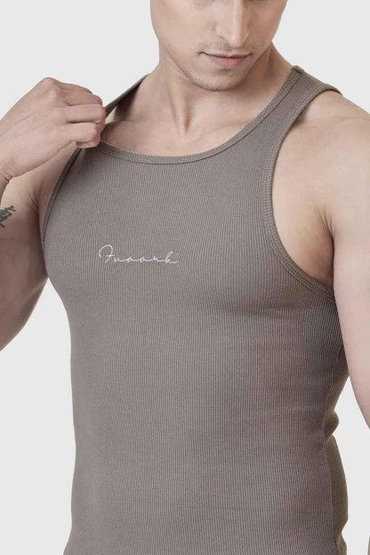 Warm beige ribbed tank top from Fuaark Nz, showcasing a fitted sleeveless design with textured ribbed fabric.