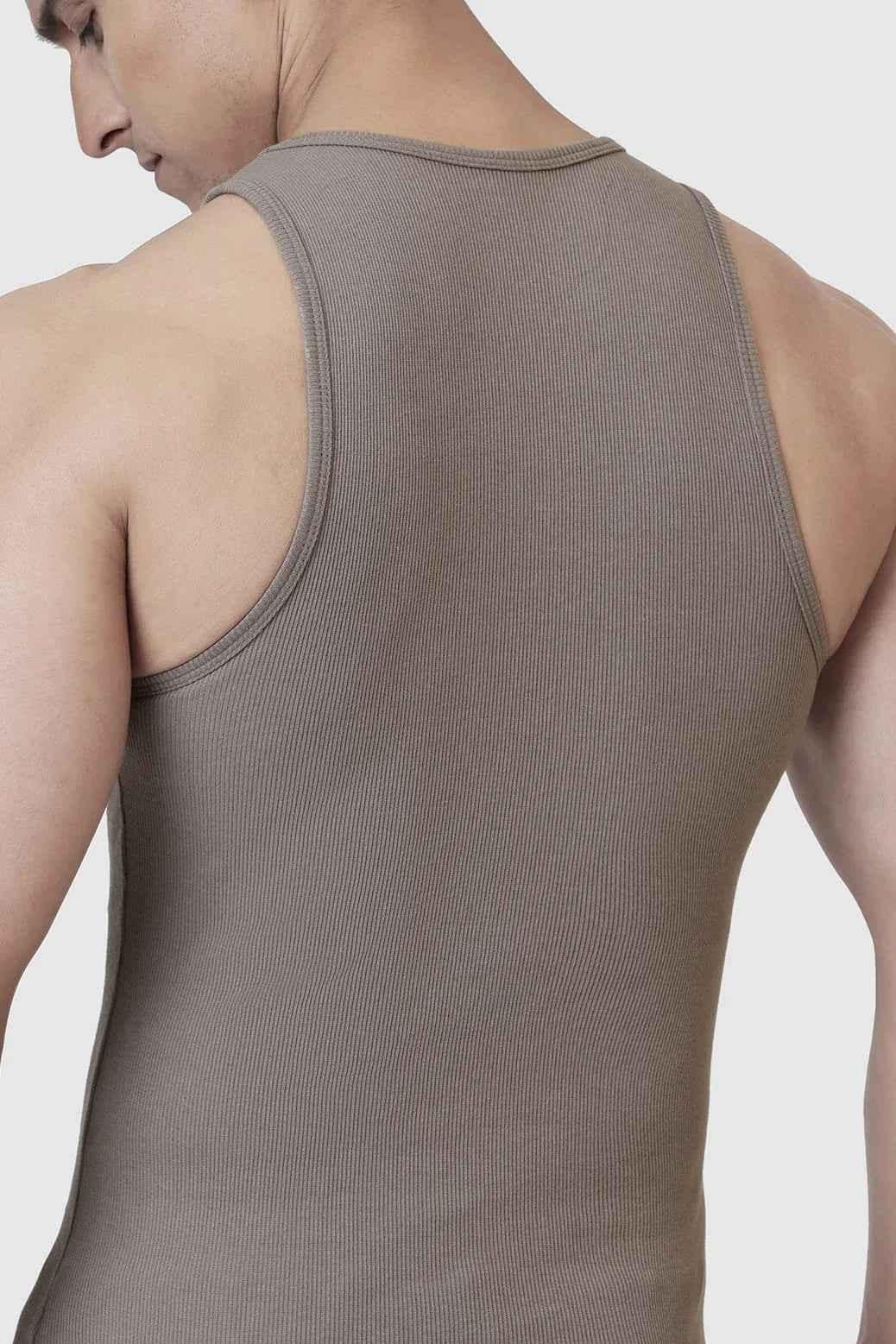 Warm beige ribbed tank top by Fuaark Nz, sleeveless, fitted style with textured ribbed fabric for casual wear.