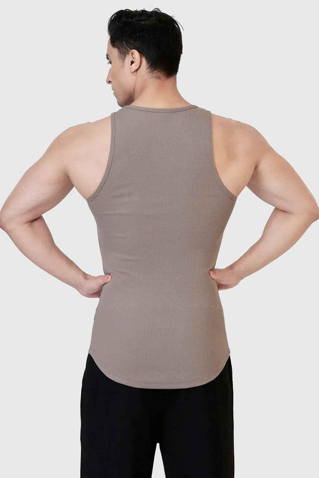 Warm beige ribbed tank top from Fuaark Nz, close-up view showing fitted design and textured fabric.