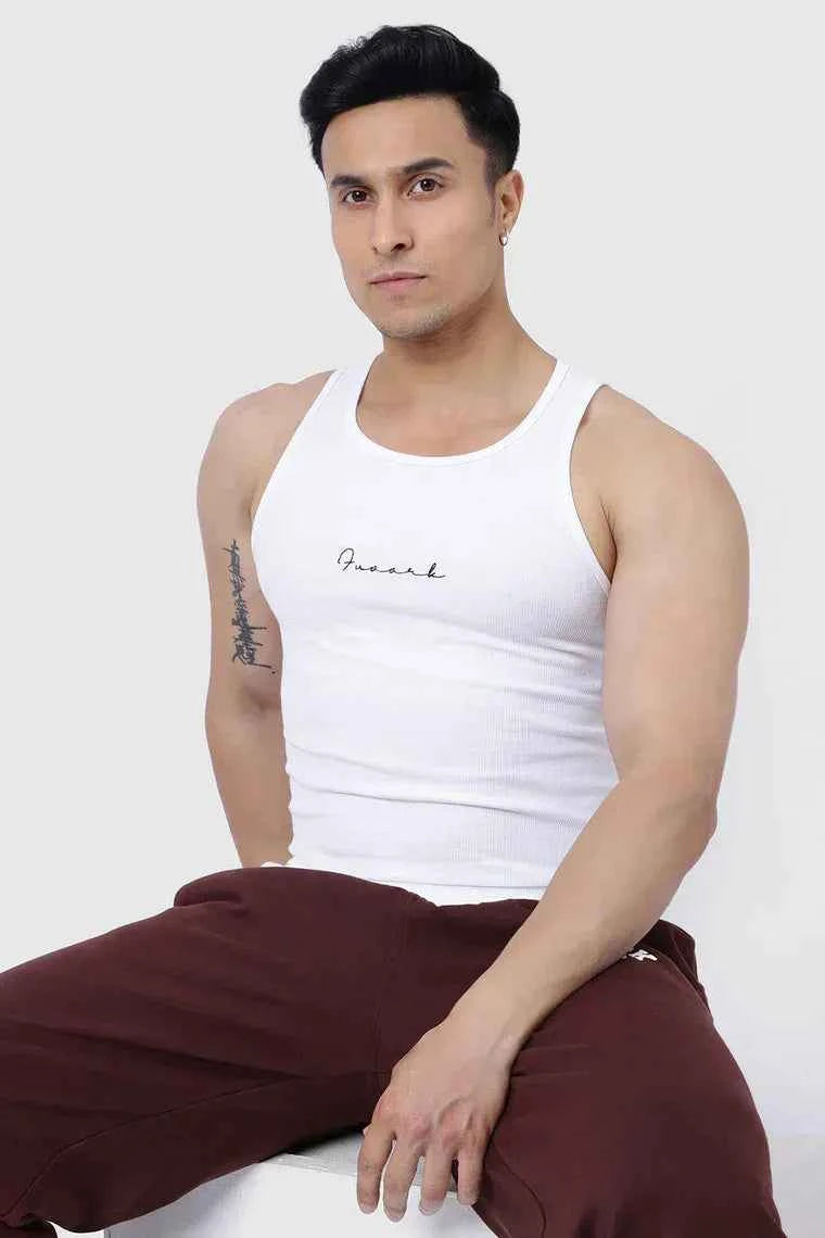 White ribbed tank top by Fuaark Nz, lightweight and fitted, shown on a model highlighting its ribbed texture and casual style.