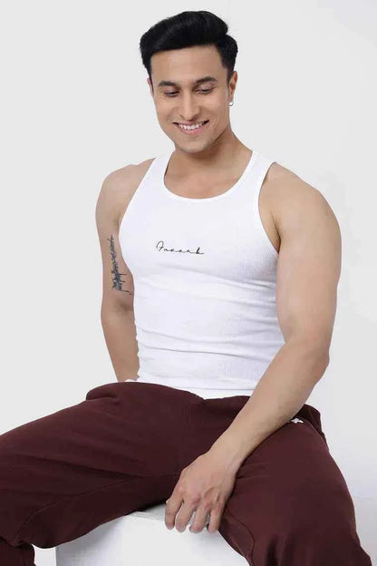 White ribbed tank top from Fuaark Nz, showcasing a close-up of the fitted, textured sleeveless shirt on a plain background.