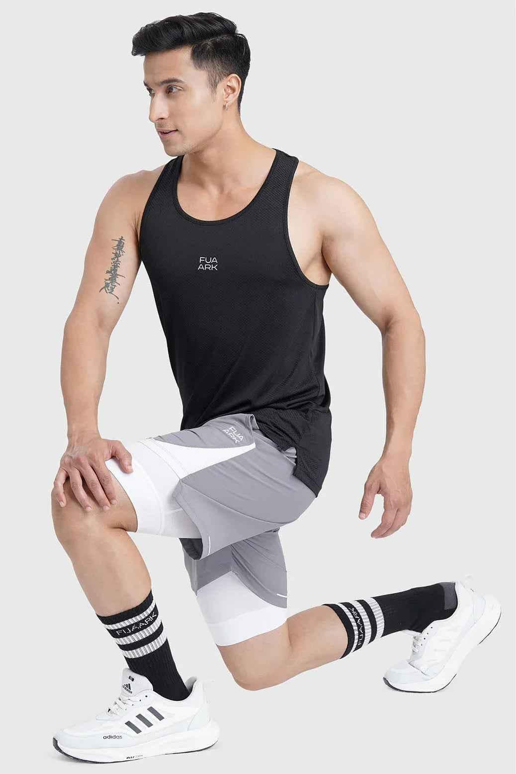 Fuaark Nz Sprint black running tank top, lightweight and breathable performance tank top for active wear, shown on a model.