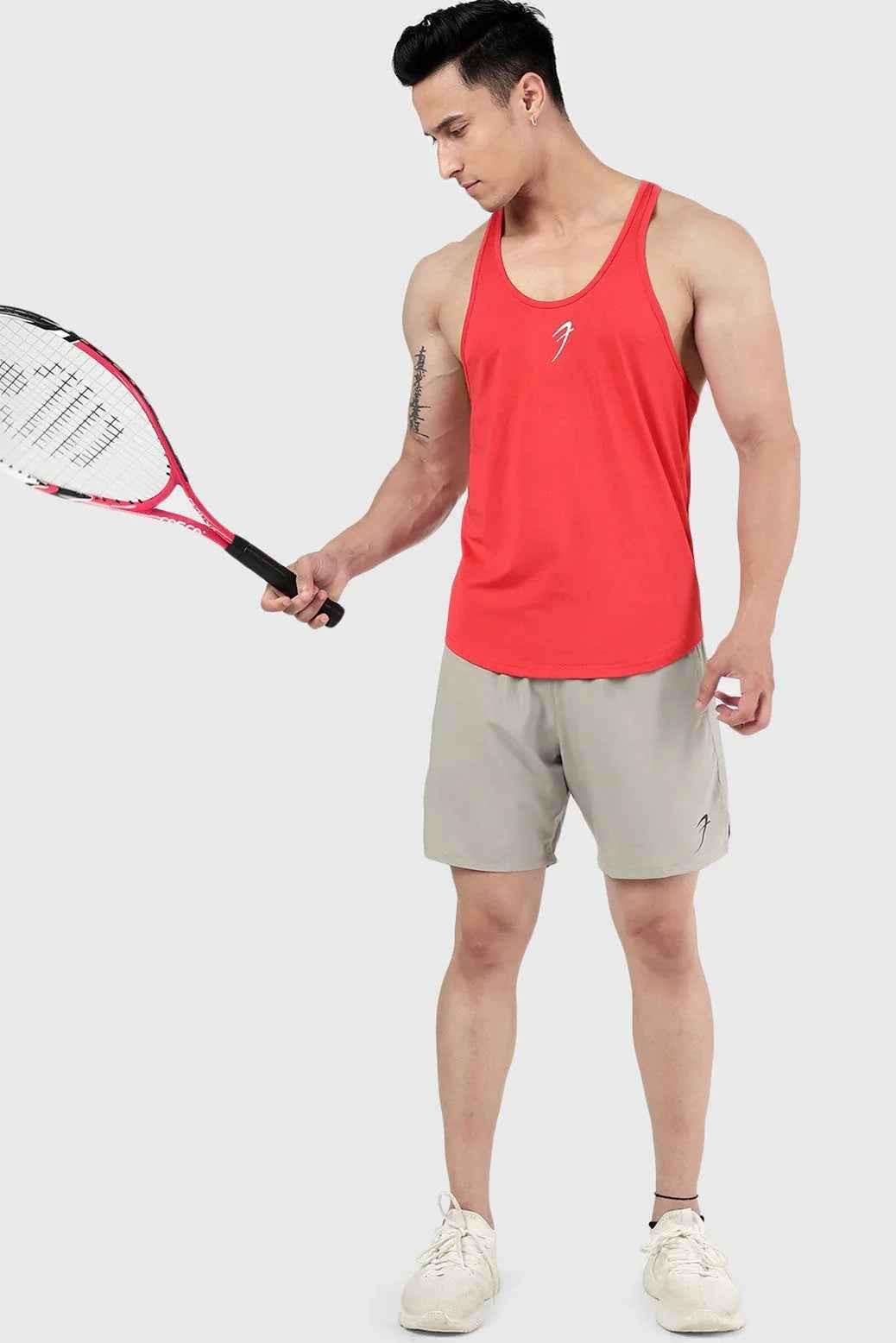 Red Surge Stringer tank top by Fuaark NZ, showing the fitted athletic sleeveless shirt with a scoop neckline.