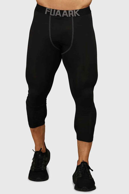 Black compression tights by Fuaark NZ, showing close-up of fitted, stretchy fabric and elastic waistband for athletic support.