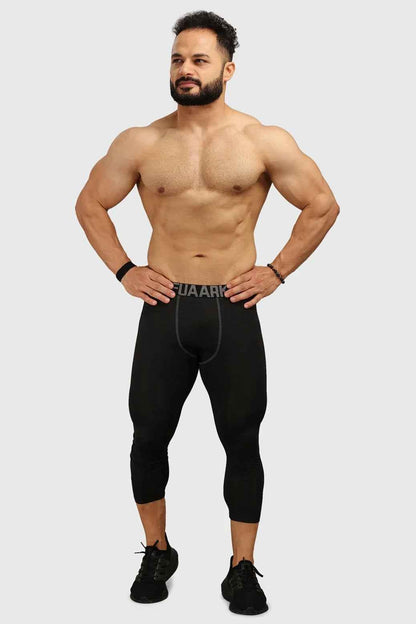 Fuaark Nz black compression tights, close-up of snug-fitting athletic tights on a model's legs.