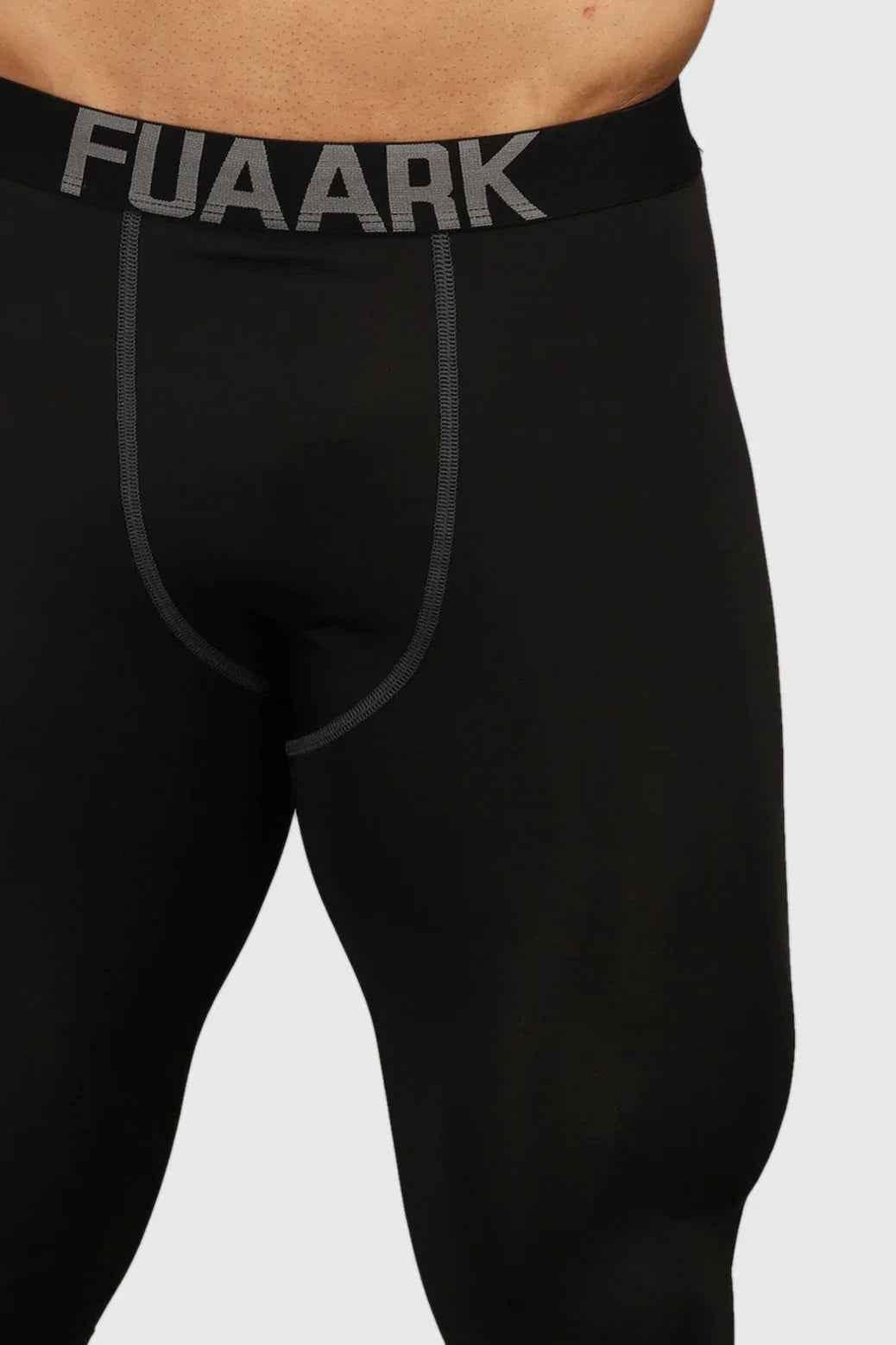Black Fuaark NZ compression tights, close-up of snug-fitting athletic tights with reinforced waistband and smooth fabric.