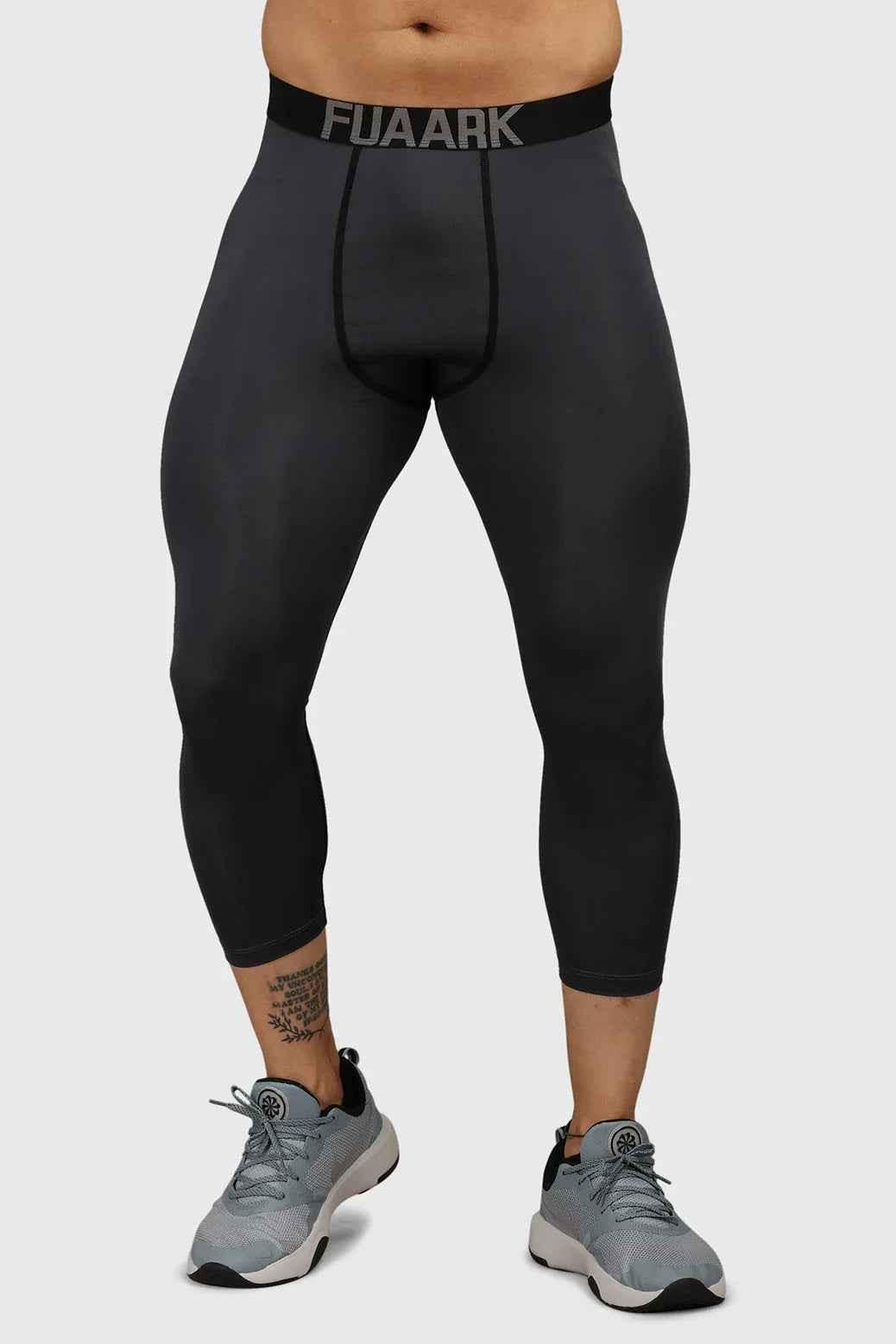 Dark grey Fuaark Nz compression tights, close-up showing snug fit and stretchy fabric, designed for comfort and support.