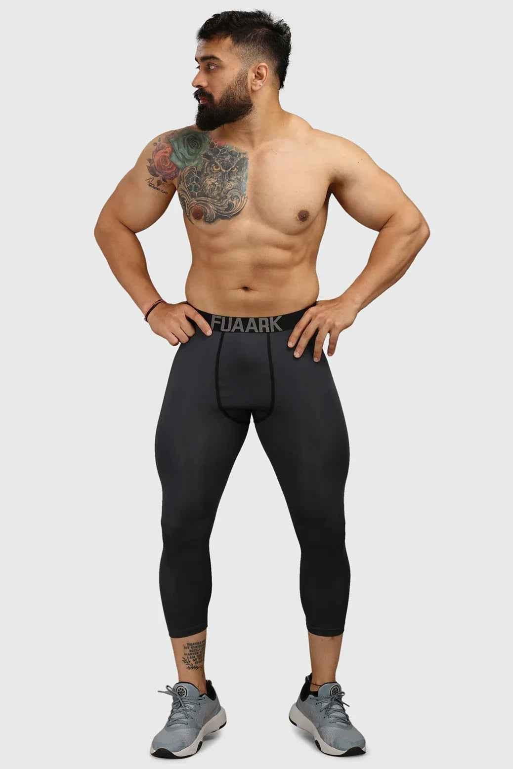 Dark grey Fuaark Nz compression tights, close-up view showing the snug fit and stretchy fabric for athletic support.