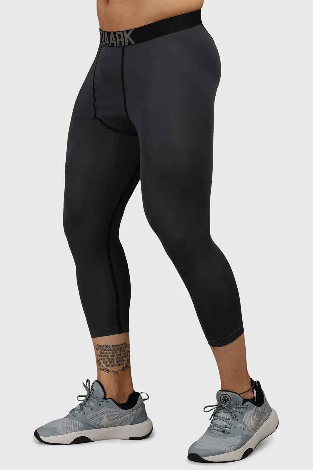 Dark grey Fuaark Nz compression tights, form-fitting tights designed for support and comfort, shown on a model.