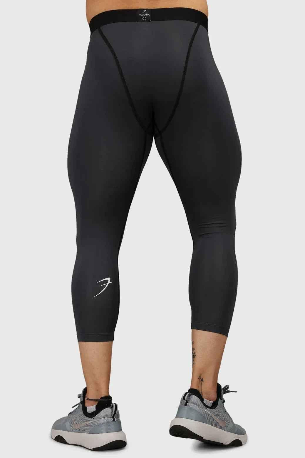 Dark grey Fuaark Nz compression tights, close-up of stretchy fabric and fitted design for athletic support and comfort.