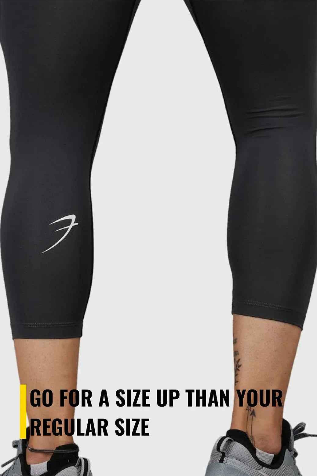 Dark grey Fuaark Nz compression tights displayed on a model, showcasing a snug fit and sleek design for athletic or casual wear.
