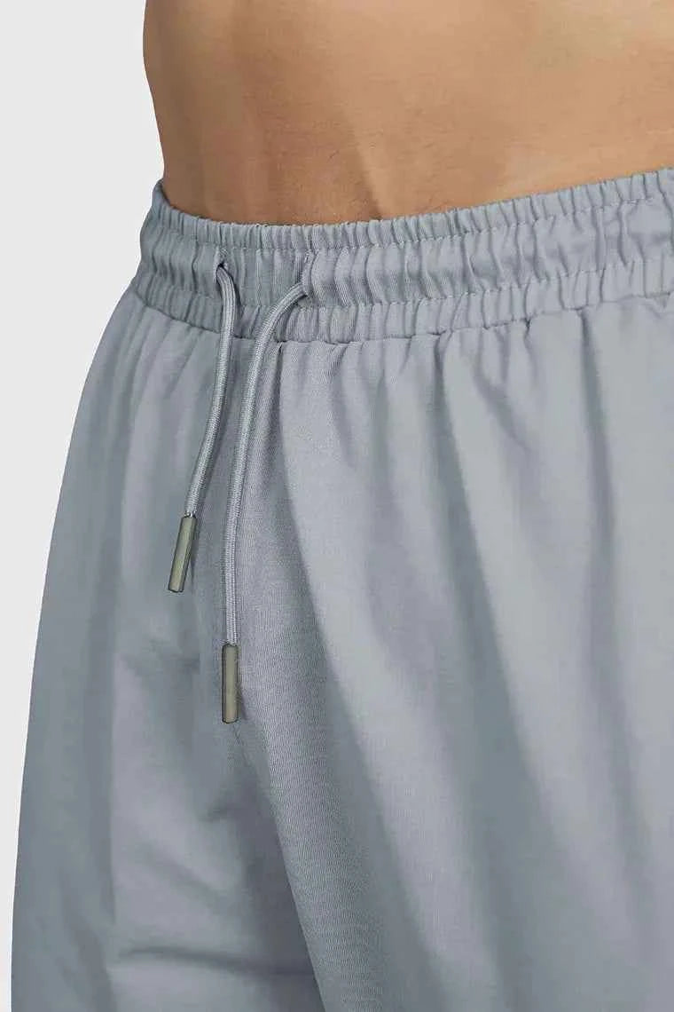 Fuaark Nz smart casual light grey track pants shown on a model, featuring a comfortable fit and modern design.