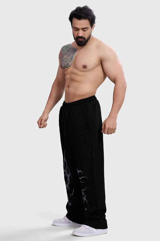 Black Phantom Straight Tracks Fuaark NZ track pants laid flat, showing the sleek design and comfortable fit.