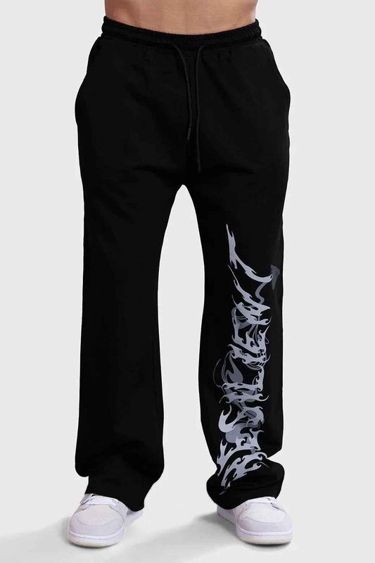 Black Ressiliant Straight Tracks Fuaark NZ track pants laid flat, showcasing their sleek design and comfortable fit.
