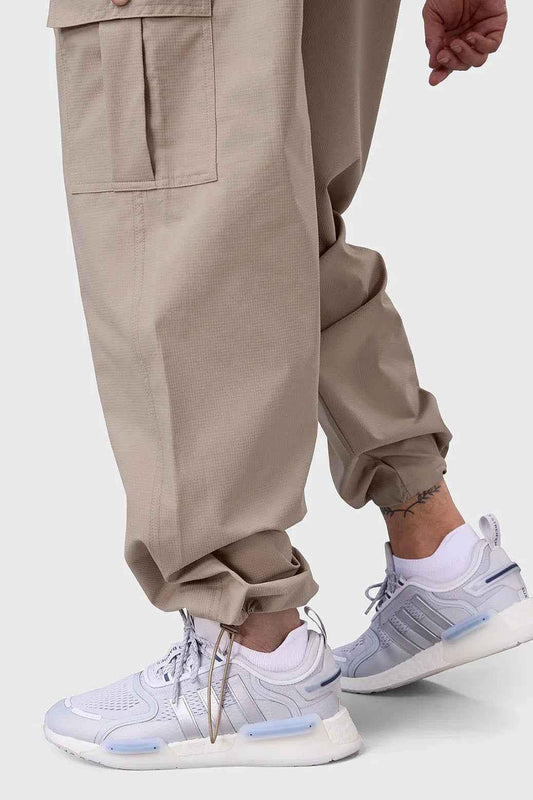 Beige Fuaark NZ Carpenter Cargo Pants with multiple pockets and relaxed fit, designed for durability and comfort.