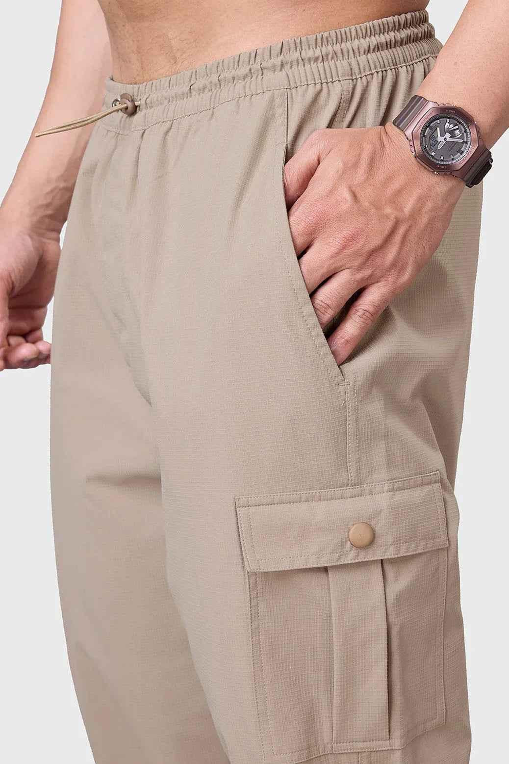 Fuaark NZ beige carpenter cargo pants with multiple pockets and a relaxed fit, designed for durability and comfort.