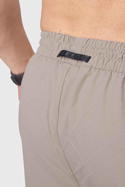 Fuaark Nz beige carpenter cargo track pants with multiple pockets and relaxed fit, suitable for work or casual wear.