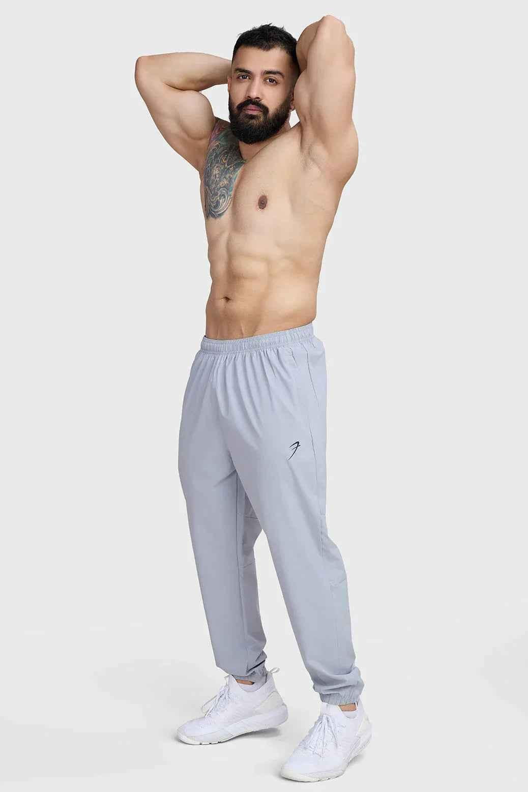 Light grey Fuaark Nz Essential Joggers track pants with a relaxed fit, featuring an elastic waistband and tapered cuffs.
