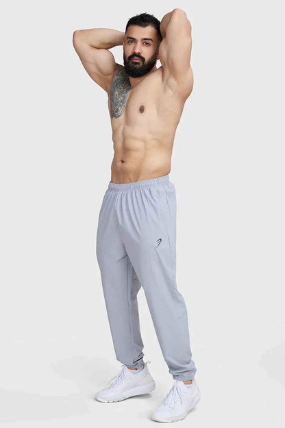 Light grey Fuaark Nz Essential Joggers track pants with a relaxed fit, featuring an elastic waistband and tapered cuffs.