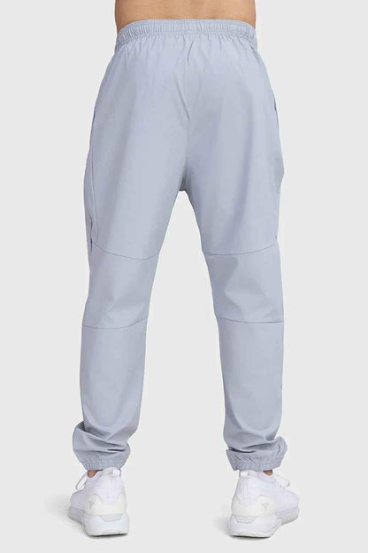 Light grey Fuaark Nz Essential Joggers, slim-fit track pants with elastic waistband and side pockets, casual athletic wear.