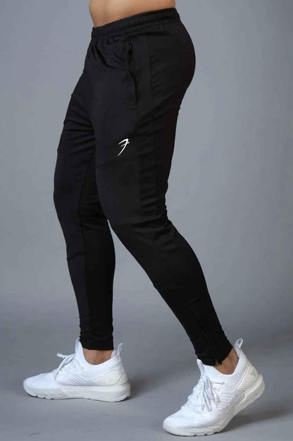 Black Fuaark Nz Hybrid Slim Tracks track shoe with sleek design and lightweight construction, shown from a side view.