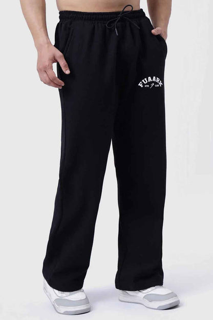 Fuaark NZ black relaxed fit track pants, laidback style, made for ultimate comfort, shown on a model in a casual setting.