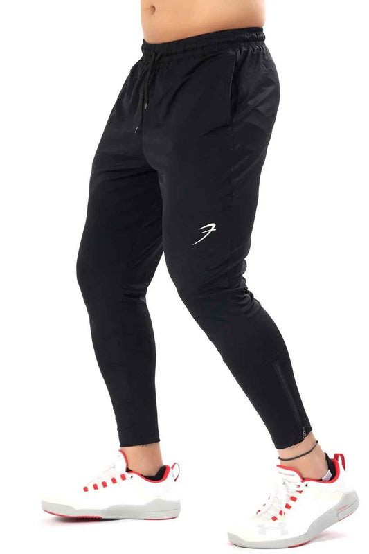 Black Nylon Supreme Tracks by Fuaark Nz, lightweight sporty track pants with a sleek design, shown in the image.