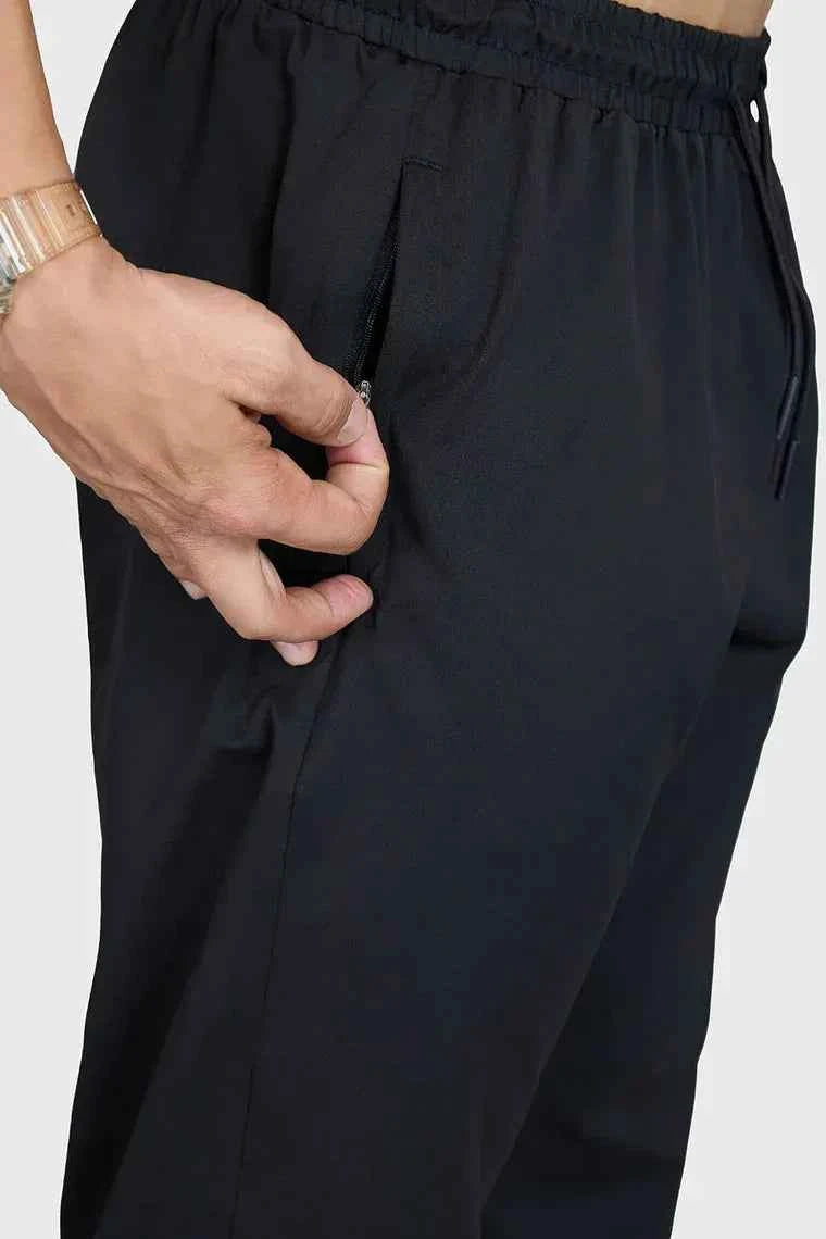 Fuaark Nz smart casual black track pants laid flat, showcasing comfortable stretch fabric and sleek design for stylish everyday wear.