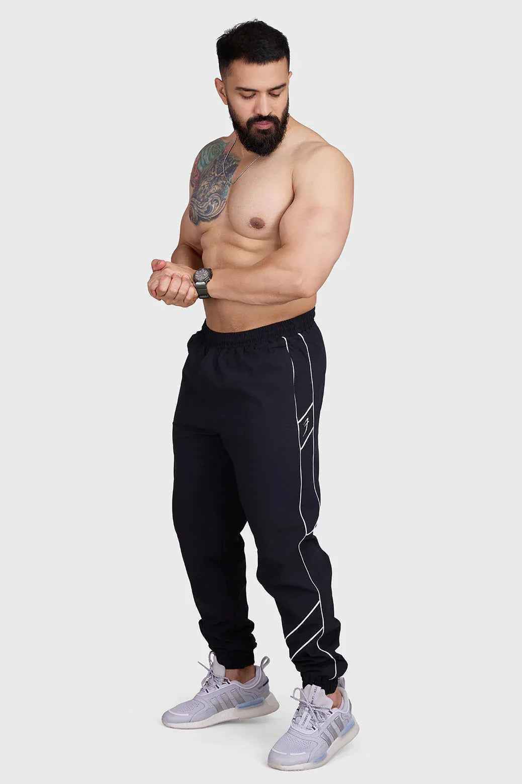 Black Fuaark Nz men's sprint track joggers, designed for comfort and performance in activewear.