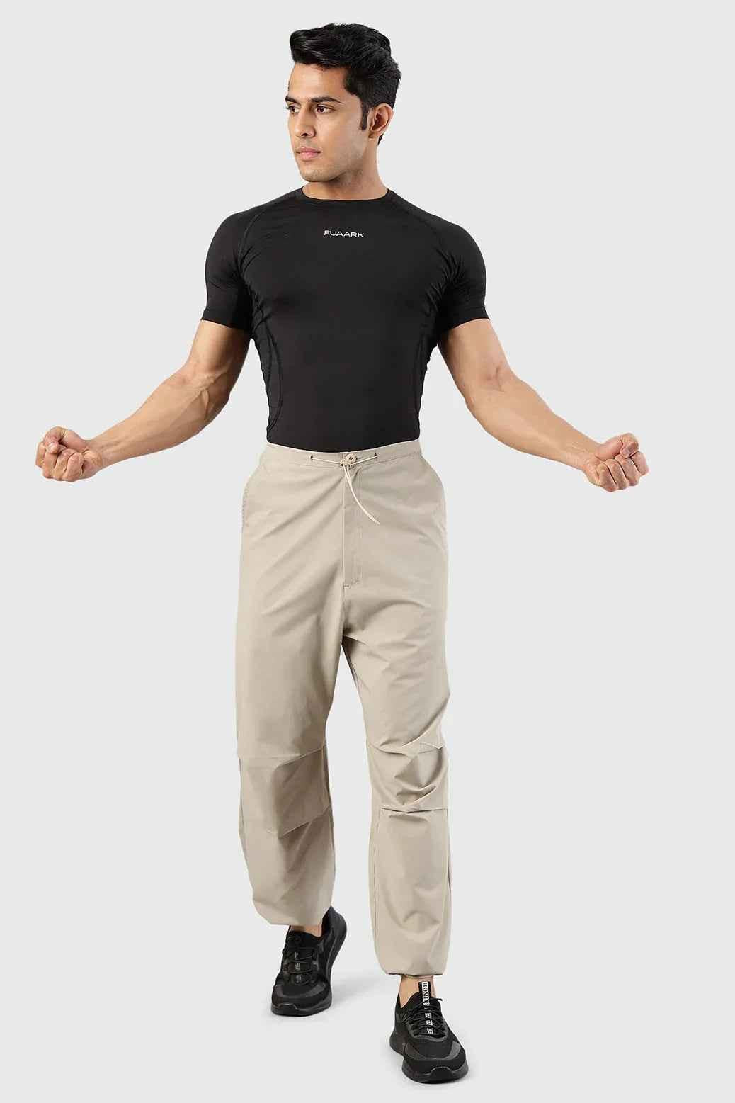 Beige Fuaark Nz Sublime Parachute Pants track pants with relaxed fit and drawstring waist, styled for casual wear.