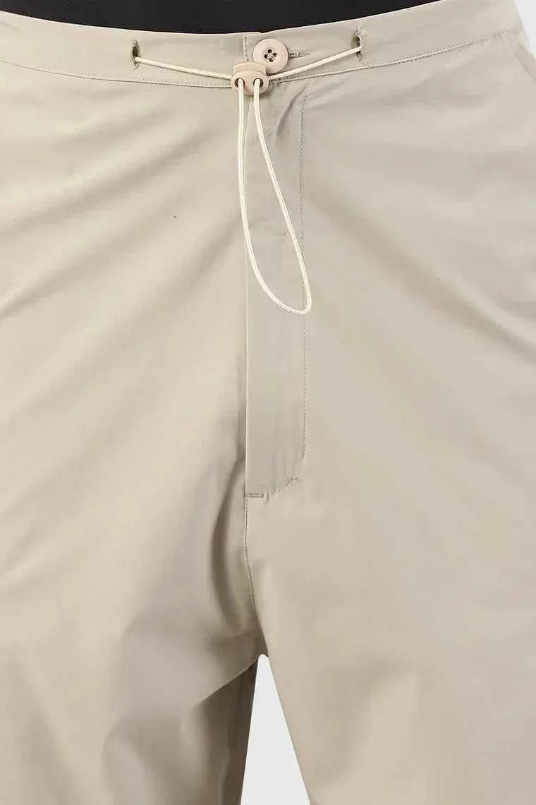 Fuaark Nz Sublime beige parachute track pants with relaxed fit and adjustable waistband, casual streetwear style.
