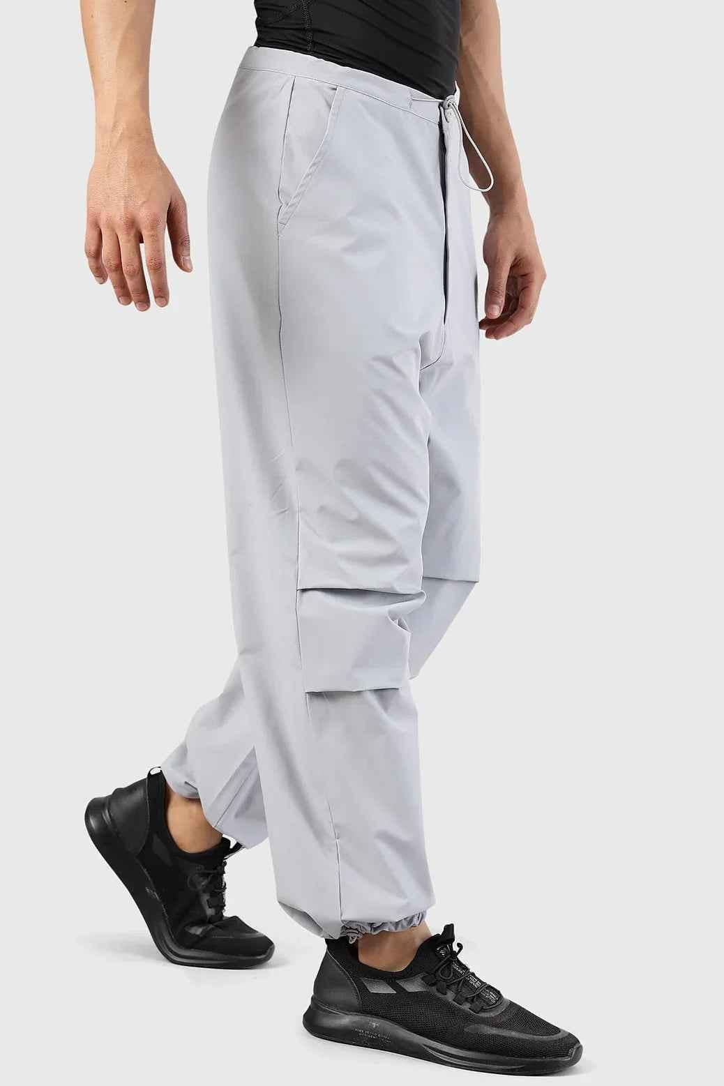 Light grey Fuaark Nz Sublime Parachute Pants track pants with relaxed fit and drawstring waist, shown on a model.