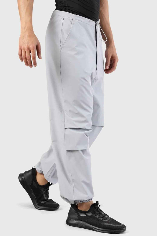 Light grey Fuaark Nz Sublime Parachute Pants track pants with relaxed fit and drawstring waist, shown on a model.