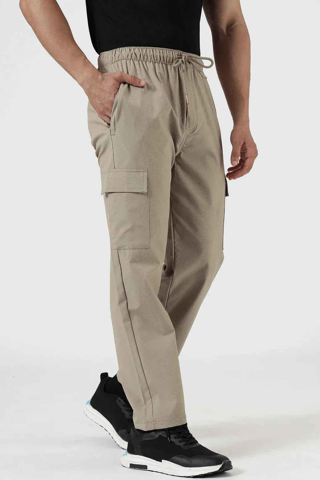 Beige Vitality Straight Pants by Fuaark Nz, casual track pants with a relaxed fit, shown on a model.