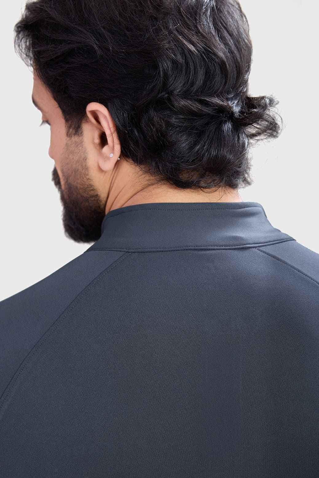 Dark grey Fuaark Nz Axis Pullover T-shirt displayed on a hanger with a close-up view of the fabric and design details.